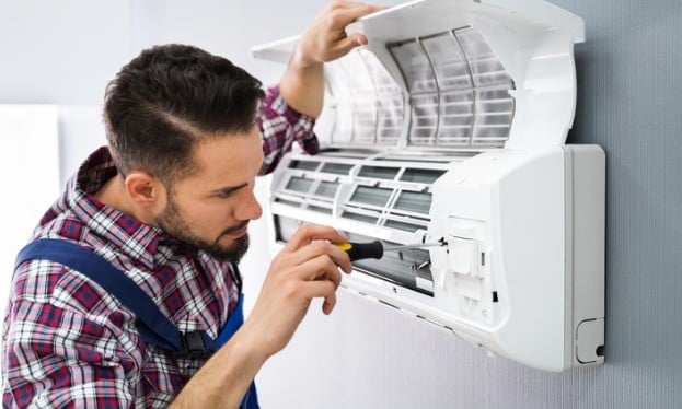 Hvac professionals installing air conditioning
