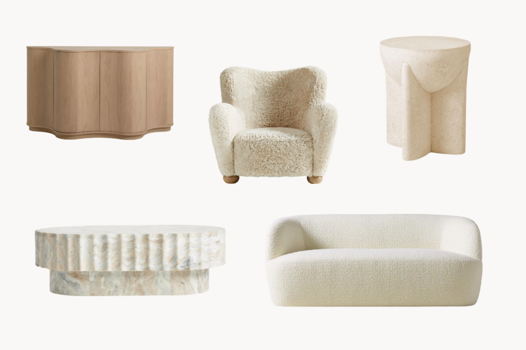 Curved wooden sideboard cream boucle armchair sculpted stone round table round marble coffee table and cream textured sofa