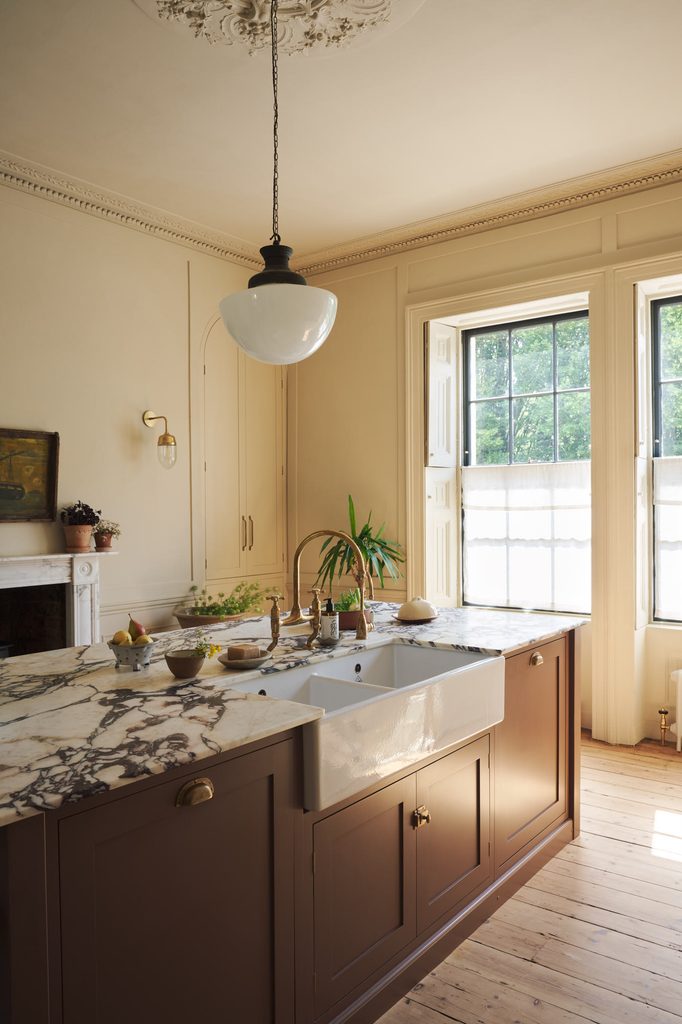 posttitle | sitetitle Traditional kitchen with marble island brown cabinets and a large sunlit window